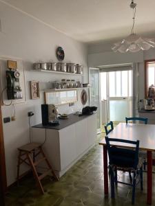 a kitchen with a table and a dining room at Casa Vincenza in Palermo