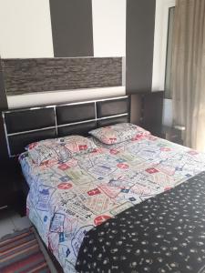 a bed with a quilt on it in a bedroom at Blue Maizon in Heraklio