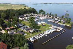 an aerial view of a marina with boats docked at Modern Tiny House op rustig Watersportpark in Elahuizen