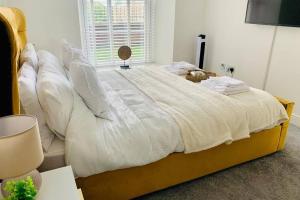 a bedroom with a large bed with white sheets and pillows at Centrally located luxury 2 bed modern apartment in Great Yarmouth