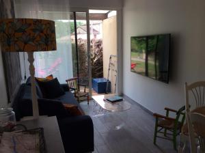 a living room with a couch and a table at Le Cottage des Mésanges in Villefranche-de-Rouergue