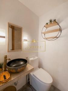 a bathroom with a white toilet and a sink at Serene Daycation Antipolo in Cupang