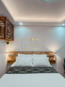 a bedroom with a bed with a sign on the wall at Serene Daycation Antipolo in Cupang