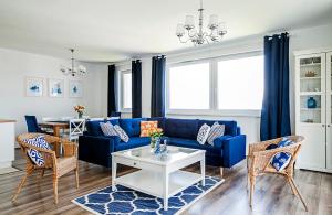 a living room with a blue couch and a table at Blue Apartments in Balatonlelle