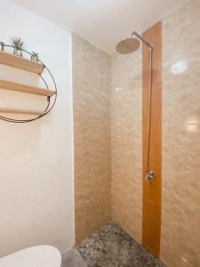a shower with a glass door in a bathroom at Serene Daycation Antipolo in Cupang