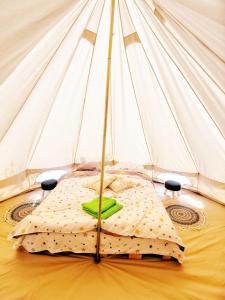 a white tent with a bed in a room at Luna Rock Glamping Brezoi - Blue Scai in Brezoi