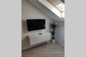 a living room with a flat screen tv on a wall at Bovec Loft apartment in Bovec