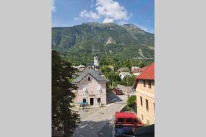 a small town with a mountain in the background at Bovec Loft apartment in Bovec