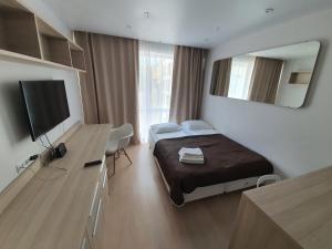 a bedroom with a bed and a large mirror at Maximus apartments Marata in Saint Petersburg