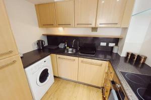 cocina con lavadora y lavadora en 1 Bedroom City Centre Apartment - Sleeps 4 Free Parking en Newcastle