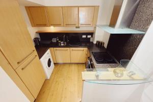 an overhead view of a small kitchen with a stove at 1 Bedroom City Centre Apartment - Sleeps 4 Free Parking in Newcastle upon Tyne