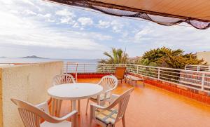 a balcony with a table and chairs and the ocean at Arpon 23c in La Manga del Mar Menor