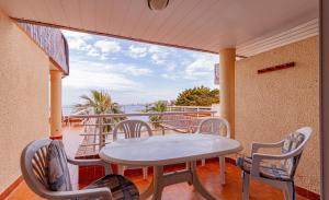 a table and chairs on a balcony with a view of the water at Arpon 23c in La Manga del Mar Menor