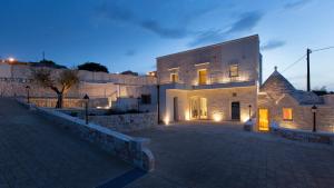 a large white building with a brick yard at night at Terrazze Sulla Valle in Martina Franca