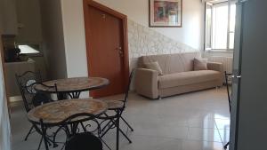 a living room with two tables and a couch at B&B Da Pietro in Matera