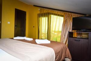 A bed or beds in a room at Guest house VRAZHDEBNA
