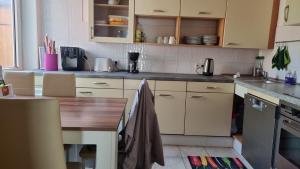 a kitchen with a wooden table and a counter top at Haus Charlotte auf Sylt, strandnah in Westerland +29 photos