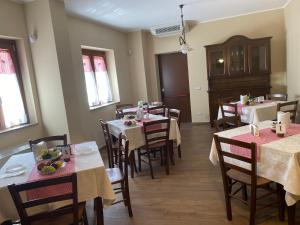 a restaurant with tables and chairs in a room at B&B NONNO MICHELE in Padula