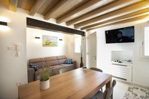 a living room with a wooden table and a couch at Casa Boscolo Family - Luxury House in Chioggia