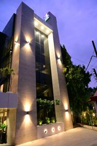 a tall building with lights on the side of it at The Eden in Indore