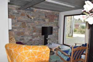 a living room with a couch and a stone wall at Piece of Race in Francorchamps