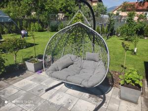 a swing chair in a yard with a garden at Apartmán Martin in Martin