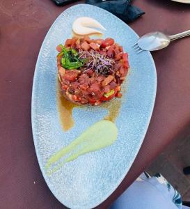 a plate of food with beans and a pickle on it at Apartament Claudia II in Puerto de Mazarrón