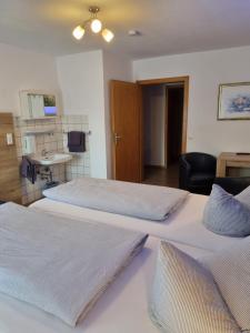 two beds in a room with a sink at Landhotel Engel in Limbach +46 photos