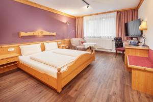 Ένα ή περισσότερα κρεβάτια σε δωμάτιο στο Hotel Am Kamin