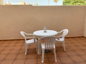 a white table and two chairs on a patio at Casita - El Rincón 23 in Torre de Benagalbón