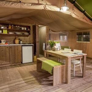 a kitchen with a table and a kitchen with a tent at Tenuta Tredici Ulivi in Senigallia