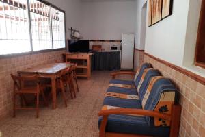 Habitación con mesa, sillas y cocina. en Casa Rural Los Cipreses. Cercados de Araña, en San Bartolomé