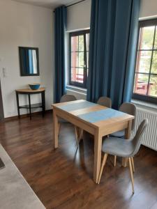 a dining room with a wooden table and chairs at Apartament 515 in Szklarska Poręba