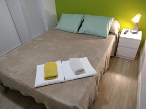 a bedroom with a bed with towels on it at PENSION132 in A Coruña