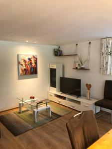 a living room with a tv and a table at Margreitterhof in Ausserbraz