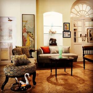 a living room with a couch and a table at Ranjit's Svaasa Amritsar in Amritsar