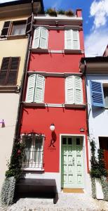 a red building with a door and a person painted on it at LE ROSSI BED in Cesena