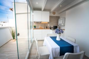 a kitchen and dining room with a table and chairs at Vico Blu in Polignano a Mare