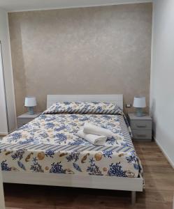 una camera con un letto con due tavoli e due lampade di Appartamento Maraviglios Alghero ad Alghero