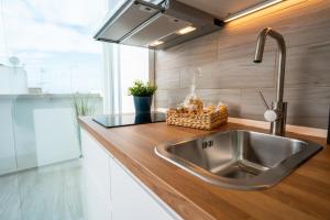 a kitchen with a stainless steel sink in a kitchen at Vico Blu in Polignano a Mare