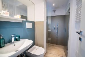 a bathroom with a toilet and a sink and a shower at Vico Blu in Polignano a Mare