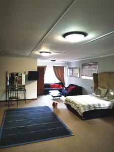 a bedroom with a bed and a dog in a room at Phantom Croft Guest Lodge in Mossel Bay