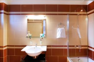 a bathroom with a sink and a shower at Miraluna Aparthotel in Lefkos Karpathou