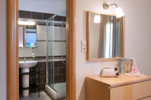 a bathroom with a sink and a mirror at Miraluna Aparthotel in Lefkos Karpathou