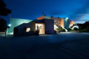 a night view of a house with lights at Miraluna Aparthotel in Lefkos Karpathou