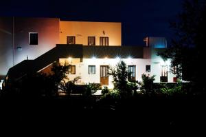 a lit up house at night with lights at Miraluna Aparthotel in Lefkos Karpathou