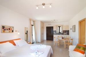 a living room with two beds and a kitchen at Miraluna Aparthotel in Lefkos Karpathou