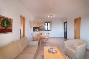 a living room with a couch and a table at Miraluna Aparthotel in Lefkos Karpathou