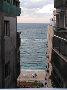 a view of the ocean from between two buildings at Zafero Studios and Apartments - Families only in Alexandria