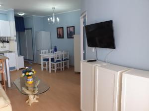 a living room with a flat screen tv on a wall at Cristianmar, Los Cristianos in Los Cristianos